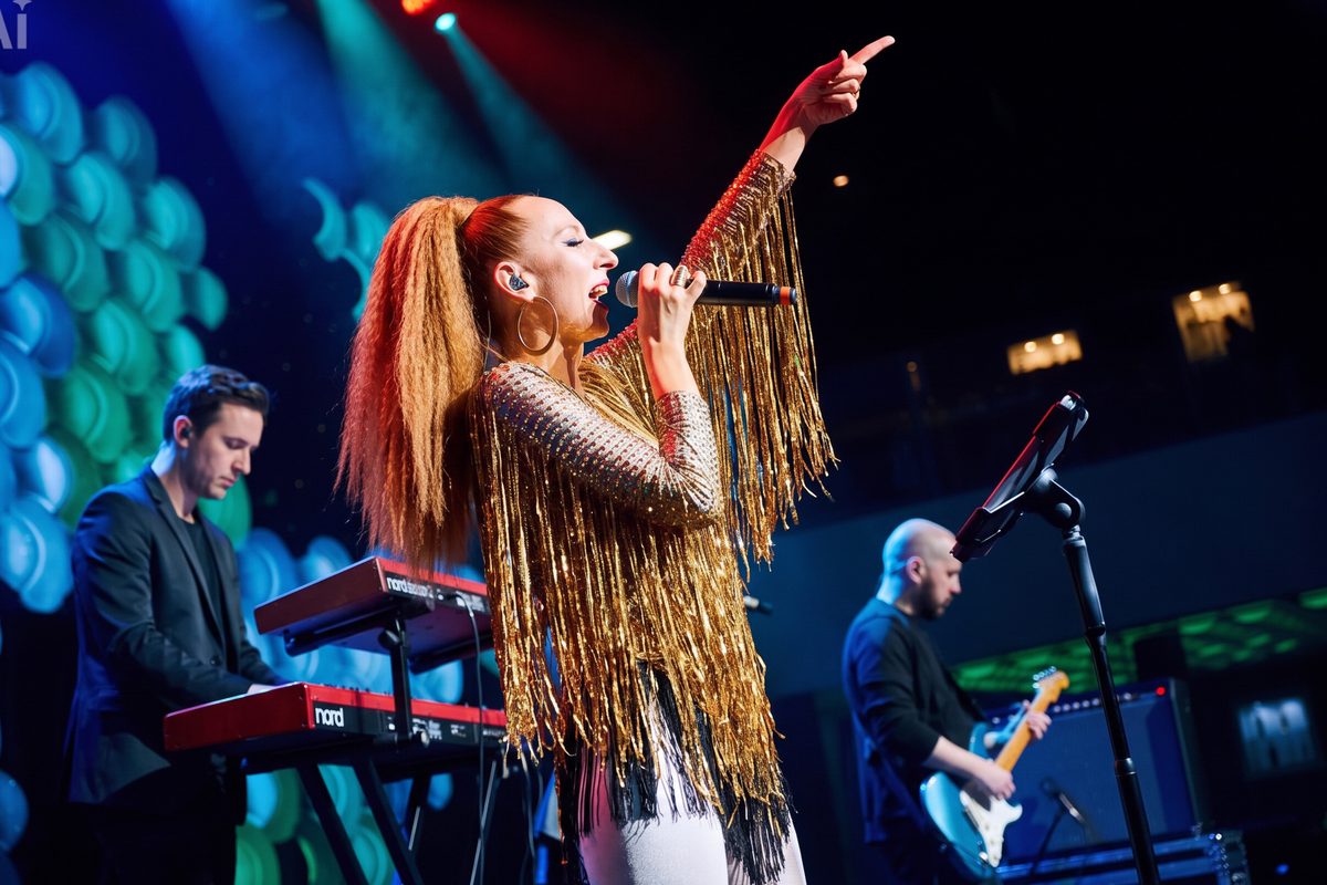 Olya Ray singing solo on stage